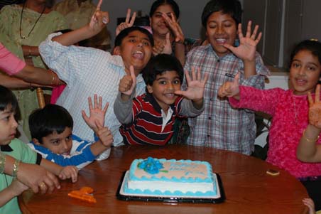 At 12.30AM, 2006, children giving a pose infront of the cake