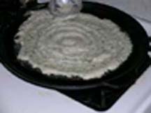 Spreading the batter in a round big circle