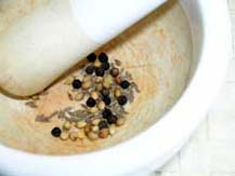 Black pepper, coriander seeds and cumin seeds in mortar